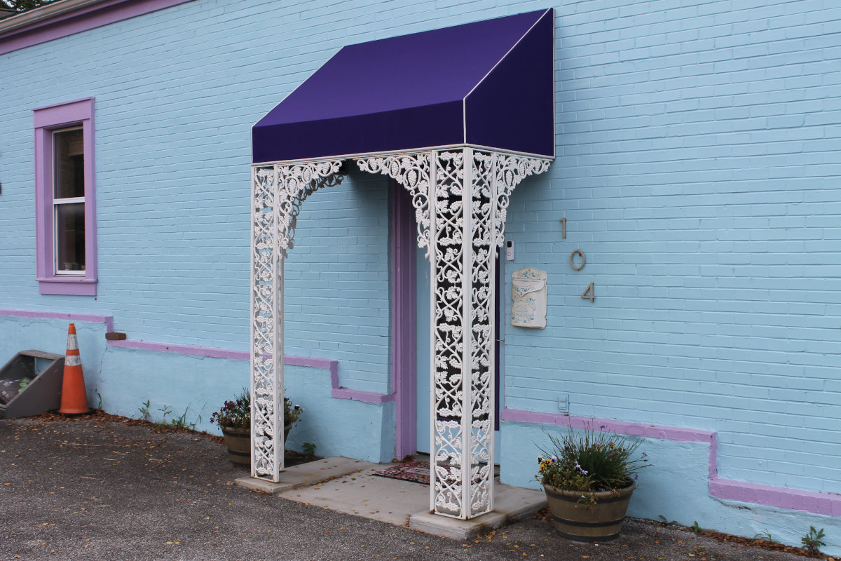 The ornate purple-trimmed entrance of Art and Soul Creative Reuse Center